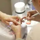 a woman getting her nails done at a nail salon